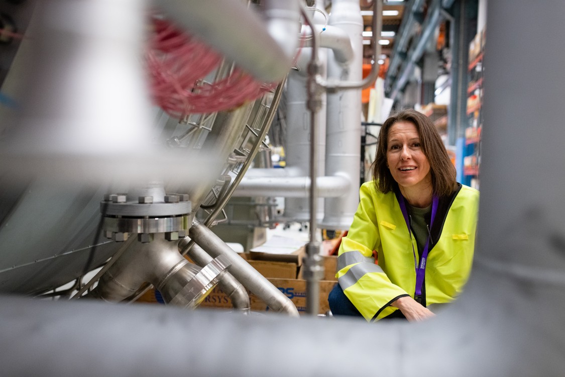 Åsa Lyckström next to an SGT-800 gas turbine in the assembly workshop, Finspång, Sweden