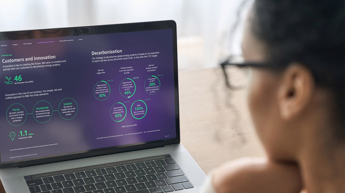 woman reading the siemens energy sustainability report on a laptop computer